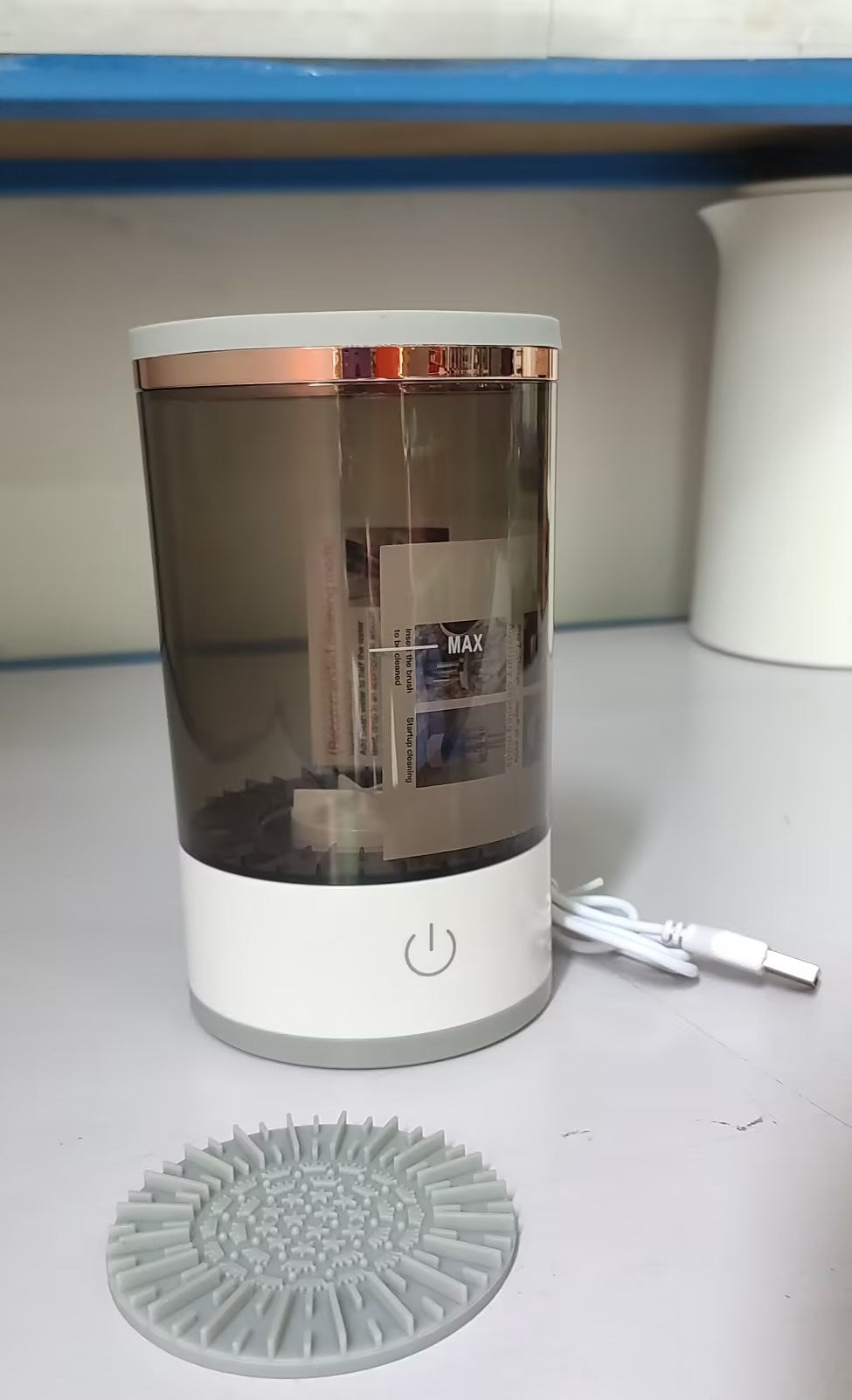 Electric makeup brush cleaner spinning a brush